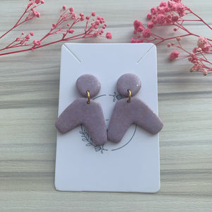 Amelia in purple-gold earrings