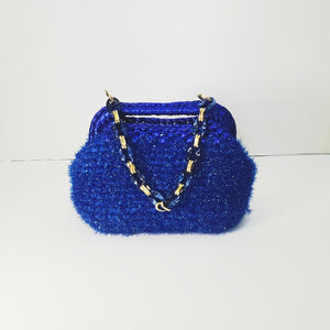 Crocheted sparkly blue clutch bag